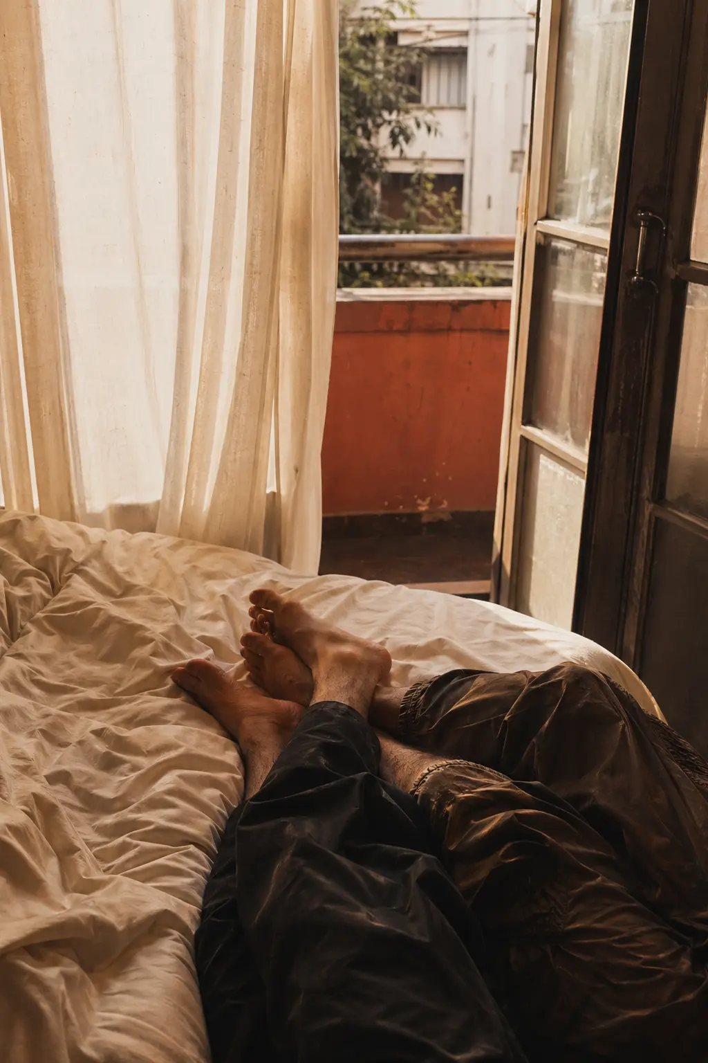 Morning bedroom scene with adult figures at the edge of frame