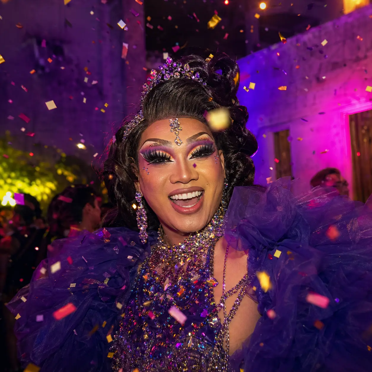 Square carnival portrait of an adult drag performer in electric color