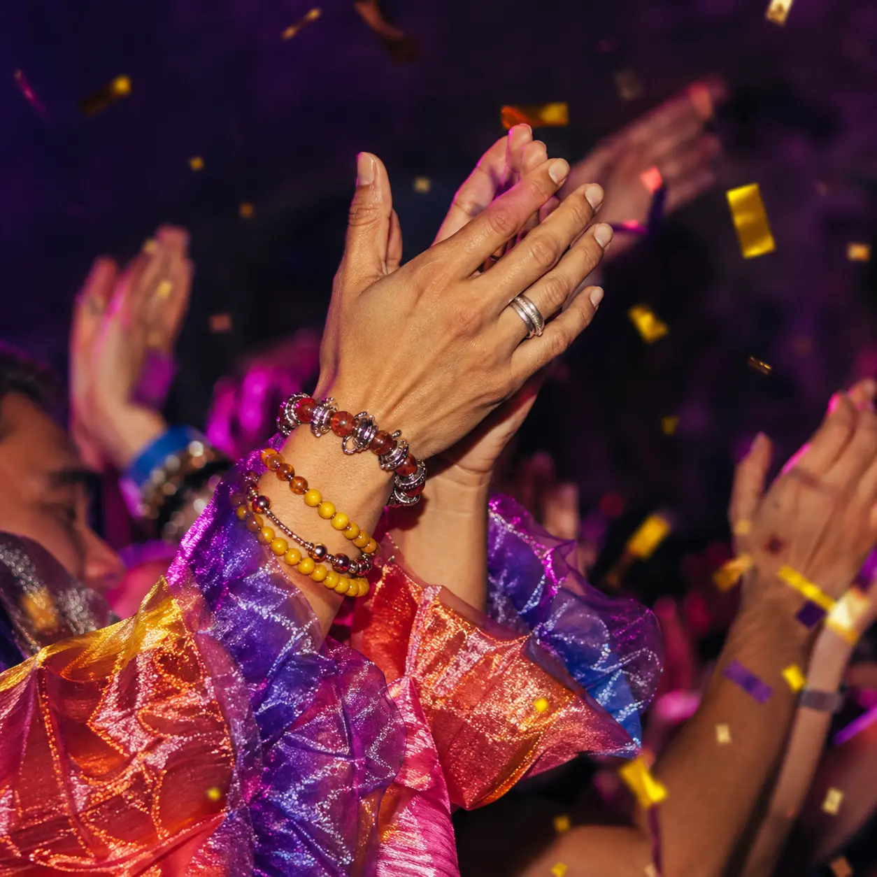 Square detail of adult hands clapping at a Pride celebration