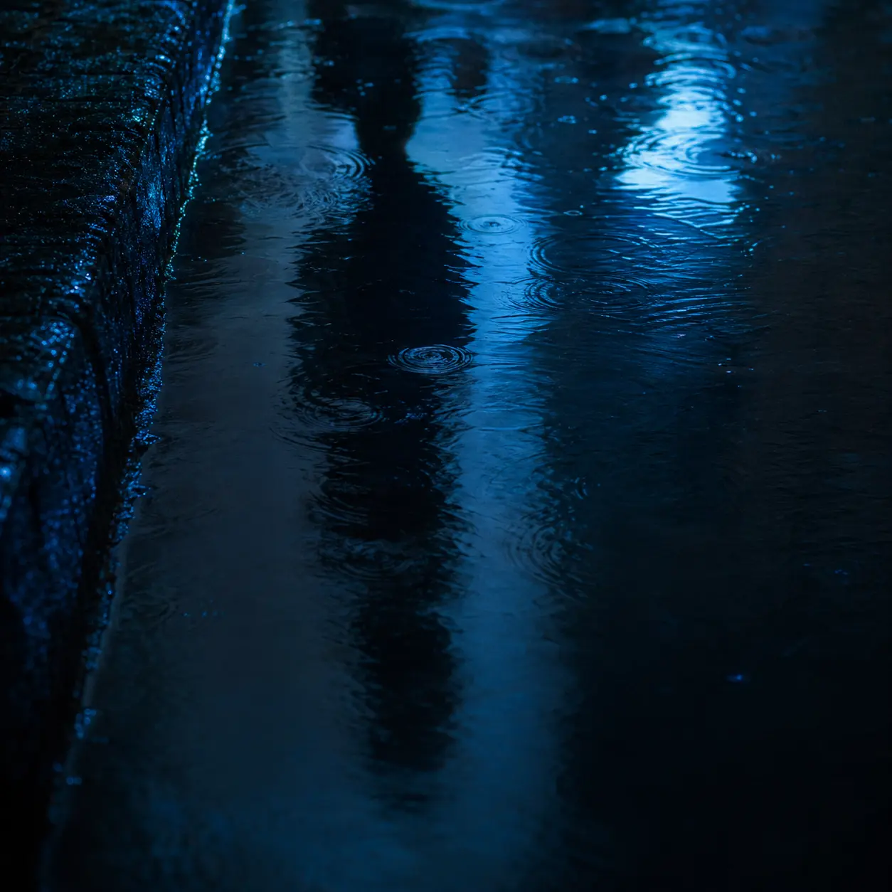 Abstract rainwater reflection of an anonymous adult man